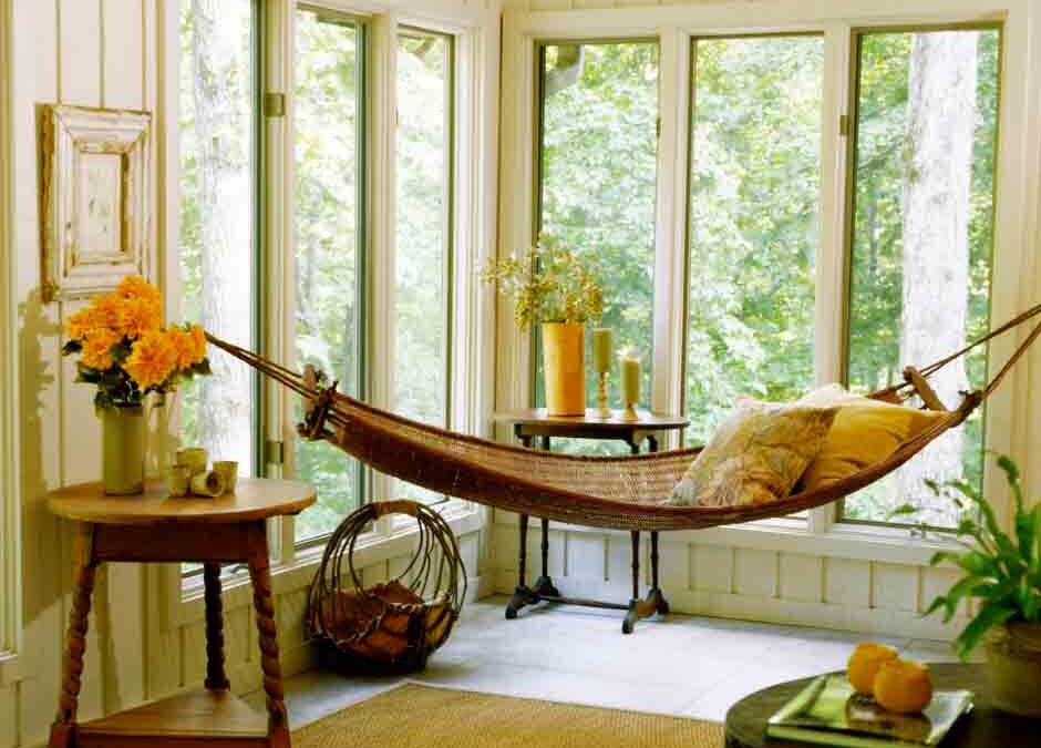A cozy hammock suspended in a bright room, surrounded by plants and soft lighting, inviting relaxation